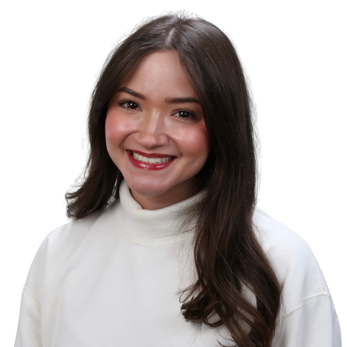 Smiling woman with long dark hair wearing a white turtleneck, photographed against a light background.